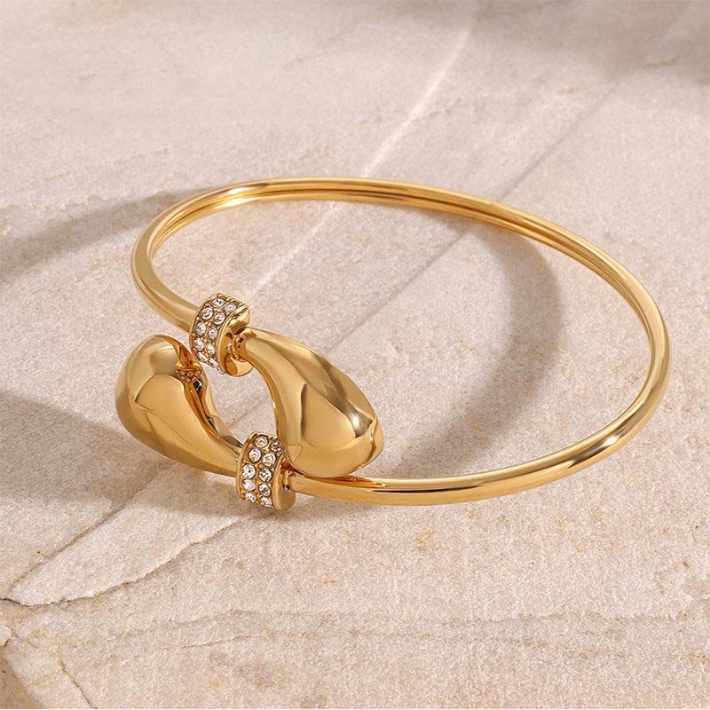 Second image of gold waterdrop diamond-embellished open bangle