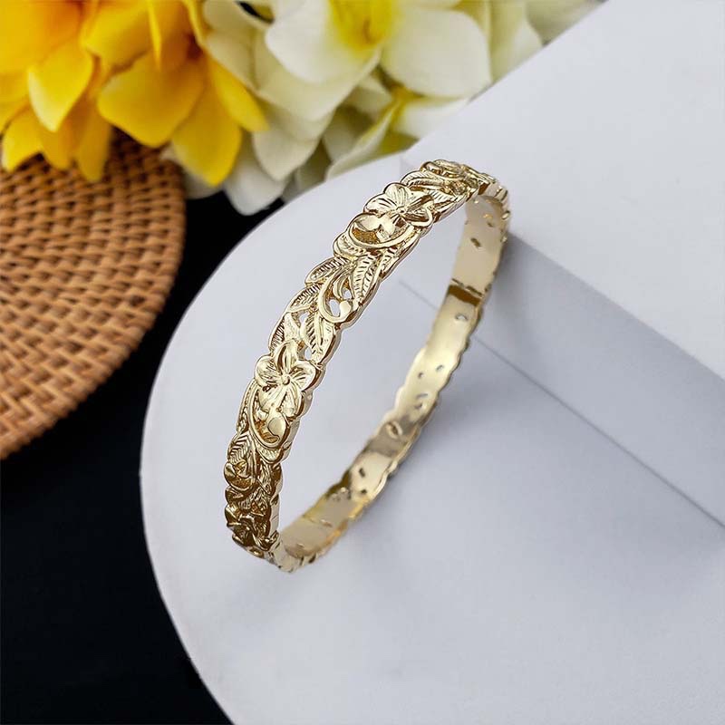 Second image of carved hollow gold bangle